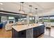 Open-concept kitchen with large island, stainless appliances, and seamless flow to the living and dining areas at 5623 Raintree Dr, Parker, CO 80134