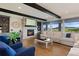 A cozy living room with a stone fireplace, beamed ceiling, and stunning views at 5623 Raintree Dr, Parker, CO 80134