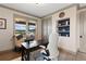 Bright home office featuring hardwood floors, a built-in shelf, and natural light at 5623 Raintree Dr, Parker, CO 80134