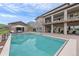 Backyard oasis with sparkling pool, lounge chairs, and a covered outdoor kitchen area at 5623 Raintree Dr, Parker, CO 80134