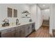 Stylish wet bar featuring custom cabinets, a wine fridge, and a modern sink and faucet at 5623 Raintree Dr, Parker, CO 80134