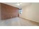 Bedroom with brick accent wall, carpet and natural light at 4258 Tennyson St # 104, Denver, CO 80212