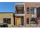 Modern brick exterior with a balcony and street-level storefront or entrance at 4258 Tennyson St # 104, Denver, CO 80212