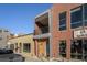 Brick building with a balcony and large windows for a storefront or commercial space at 4258 Tennyson St # 104, Denver, CO 80212