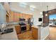 Modern kitchen featuring stainless steel appliances, wooden cabinetry, and breakfast bar seating at 4258 Tennyson St # 104, Denver, CO 80212