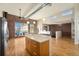 Kitchen island with cabinets and breakfast bar overlooking open living area and exposed brick wall at 4258 Tennyson St # 104, Denver, CO 80212
