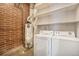 Laundry area with washer, dryer, water heater, and shelving for storage at 4258 Tennyson St # 104, Denver, CO 80212