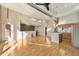 Open-concept living area with hardwood floors, stainless steel appliances, and a brick wall at 4258 Tennyson St # 104, Denver, CO 80212