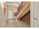 Modern staircase with brick accent wall, wood stairs, and concrete floor at 4258 Tennyson St # 104, Denver, CO 80212
