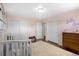 Charming Bedroom with soft pink walls, a cozy crib, and ample storage, creating a calming environment at 2502 S Lima St, Aurora, CO 80014