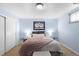 Bedroom with light blue walls, decorative art, and bedside tables at 2502 S Lima St, Aurora, CO 80014
