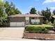 Charming brick home with a three-car garage, mature trees, and a well-maintained front yard at 2502 S Lima St, Aurora, CO 80014