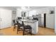 Eat-in kitchen with stainless steel appliances, granite countertops, and a breakfast bar with seating at 2502 S Lima St, Aurora, CO 80014
