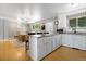 Open kitchen with granite counters, stainless appliances, white cabinets, and breakfast bar with seating at 2502 S Lima St, Aurora, CO 80014