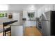 Bright eat-in kitchen featuring granite countertops, stainless appliances and white cabinets for storage and convenience at 2502 S Lima St, Aurora, CO 80014