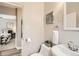 This bathroom features a pedestal sink and a view into the bedroom at 1237 Tamarac St, Denver, CO 80220