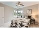 This cozy bedroom features a ceiling fan and a bright window nook with views of the neighborhood at 1237 Tamarac St, Denver, CO 80220