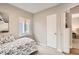 This bedroom features a bright window, carpet, and comfortable bed at 1237 Tamarac St, Denver, CO 80220