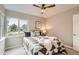 This bedroom features a comfortable bed, neutral paint and carpet, and a bright window at 1237 Tamarac St, Denver, CO 80220