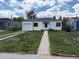 Charming single-story home featuring a well-maintained front yard and attached one car garage at 1237 Tamarac St, Denver, CO 80220