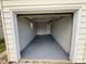 Spacious garage with painted floor, providing ample parking and storage, complemented by a functional and clean interior at 1237 Tamarac St, Denver, CO 80220