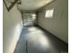 Well-lit garage featuring a concrete floor and an overhead door, providing secure parking and storage space for residents at 1237 Tamarac St, Denver, CO 80220