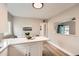 Bright kitchen with white countertops and island, seamlessly connected to the living area, and lots of counter space at 1237 Tamarac St, Denver, CO 80220