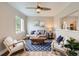 Inviting living room featuring a comfortable seating area, neutral walls, and a seamless view to the adjacent kitchen at 1237 Tamarac St, Denver, CO 80220