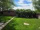 Large backyard with a well-maintained lawn and mature trees offering plenty of shade at 2285 Ironton St, Aurora, CO 80010