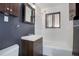 Clean bathroom with vanity, shower, and a window for natural light at 2285 Ironton St, Aurora, CO 80010