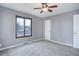 Bright bedroom featuring neutral walls, carpet, a ceiling fan, and a window offering plenty of natural light at 2285 Ironton St, Aurora, CO 80010