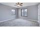 Spacious bedroom with neutral walls, carpet, ceiling fan, and large windows, offering ample natural light at 2285 Ironton St, Aurora, CO 80010