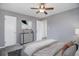 Staged bedroom featuring carpet, a ceiling fan, neutral walls, and stylish decor at 2285 Ironton St, Aurora, CO 80010