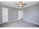 Neutral bedroom featuring carpet, a ceiling fan, and two doors, offering a cozy retreat at 2285 Ironton St, Aurora, CO 80010