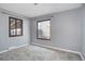 Bedroom featuring a large window, fresh paint, and new carpet at 2285 Ironton St, Aurora, CO 80010