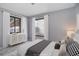 Virtually staged bedroom featuring a large window, new carpet, and minimalist decor at 2285 Ironton St, Aurora, CO 80010