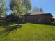 Quaint brick home featuring a lush lawn, newly planted tree and well-maintained landscape at 2285 Ironton St, Aurora, CO 80010