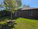 Quaint brick home featuring a lush lawn, newly planted tree and well-maintained landscape at 2285 Ironton St, Aurora, CO 80010