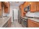 Updated kitchen with stainless steel appliances and granite countertops at 2285 Ironton St, Aurora, CO 80010