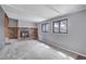 Bright living room features a charming brick fireplace and large windows at 2285 Ironton St, Aurora, CO 80010