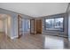 Bright living room with hardwood floors, large window, and an open layout with new glass door at 2285 Ironton St, Aurora, CO 80010