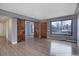 Bright living room with hardwood floors, large window, and an open layout with new sliding doors at 2285 Ironton St, Aurora, CO 80010
