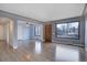 Bright living room with hardwood floors, large window, and an open layout to dining area at 2285 Ironton St, Aurora, CO 80010