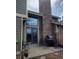 Cozy back patio area with an outdoor grill and seating near a brick chimney, perfect for entertaining at 10806 W Evans Ave # 5, Lakewood, CO 80227