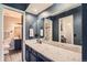 Bathroom featuring granite countertops, and a view of the walk-in closet at 10806 W Evans Ave # 5, Lakewood, CO 80227