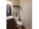 Powder bathroom featuring a modern toilet, vanity with a sink, and neutral wall color at 10806 W Evans Ave # 5, Lakewood, CO 80227