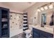 Stylish bathroom featuring custom vanity with granite counters, tiled shower, and modern fixtures at 10806 W Evans Ave # 5, Lakewood, CO 80227