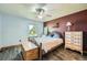 Cozy bedroom showcasing a bed, wood-look flooring, a window, and decorative furnishing for a relaxing retreat at 10806 W Evans Ave # 5, Lakewood, CO 80227