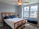 Bedroom with two windows, bed, bench, and ceiling fan offering natural light and ventilation at 10806 W Evans Ave # 5, Lakewood, CO 80227