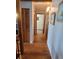 Hallway with hardwood floors and neutral paint, complemented by wooden doors and trim accents at 10806 W Evans Ave # 5, Lakewood, CO 80227